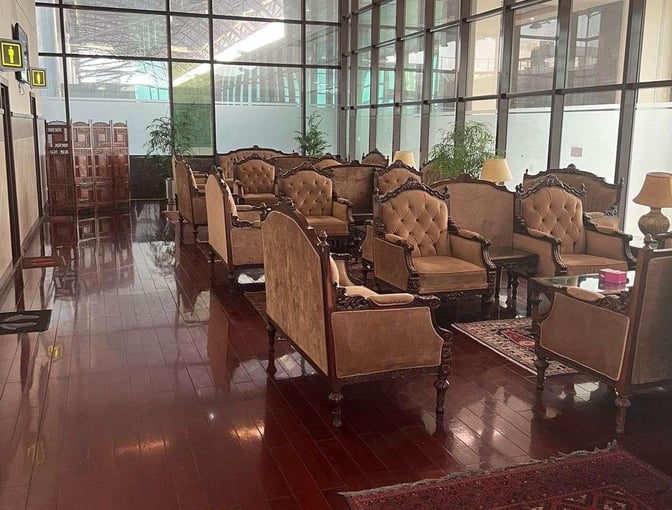 The CIP Lounge at Peshawar Bacha Khan International Airport features upholstered seating and tables in a spacious, glass-walled area.