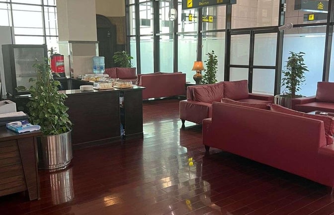 The CIP Lounge at Peshawar Bacha Khan International Airport features comfortable seating and a refreshment counter with snacks and drinks.