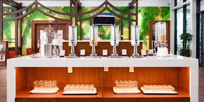 The SH Premium Lounge at Phu Cat Airport features a self-serve beverage station with dispensers.