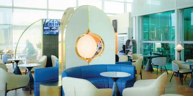 The SENS Leisure Lounge at Phu Quoc International Airport features a seating area with round tables and a partition for privacy.