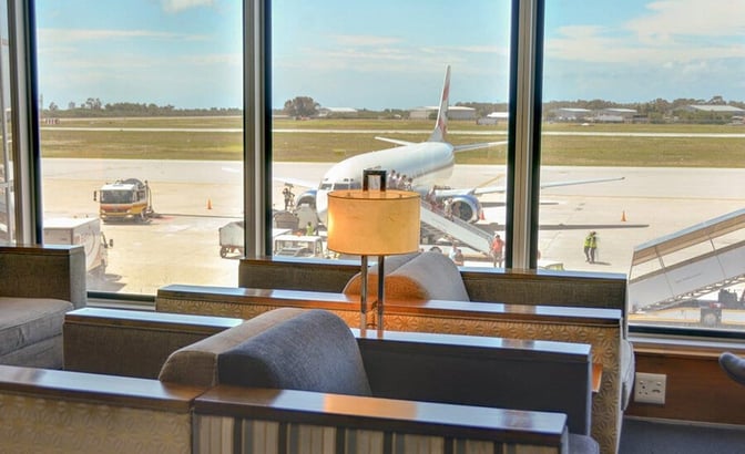 Seating in the Bidvest Premier Lounge at Port Elizabeth International Airport offers views of the runway and aircraft boarding area.