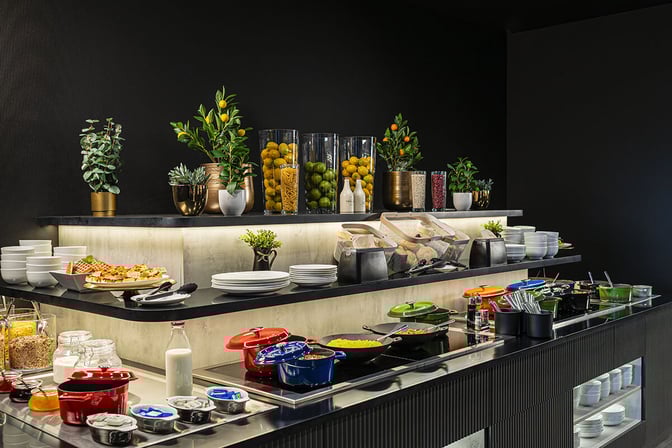 Self-serve food station at the Mastercard Lounge in Prague Airport offers a variety of hot and cold meal options.