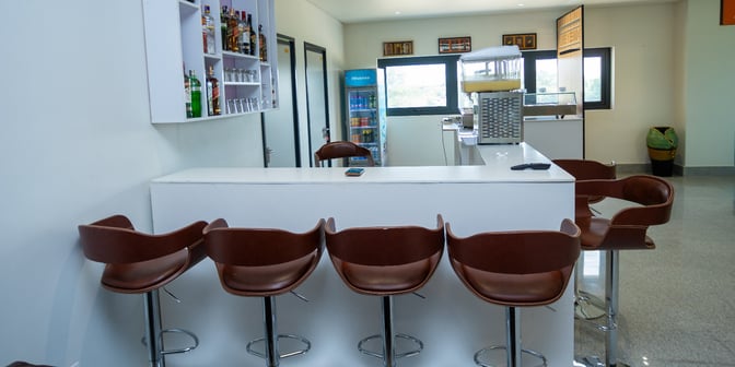 The CIP Lounge at Prempeh I International Airport features a bar area with counter seating and a selection of beverages.