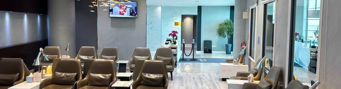 The seating area in Hayyak Lounge at Prince Abdul Mohsin bin Abdulaziz International Airport features comfortable chairs and small tables for travelers.