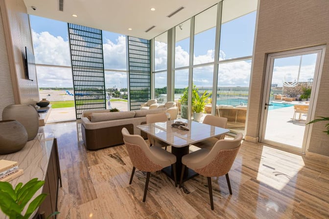 The VIP Lounge at Punta Cana International Airport features seating with views of the runway and access to an outdoor area.