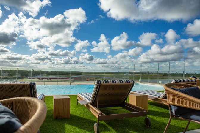 The VIP Lounge at Punta Cana International Airport features outdoor seating with lounge chairs overlooking the runway and surrounding landscape.