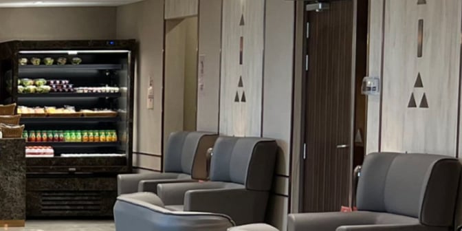 The Hayyak Lounge at Qaisumah–Hafar Al-Batin International Airport features a seating area with armchairs and a self-serve snack station.
