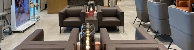 The seating area in Hayyak Lounge at Qaisumah–Hafar Al-Batin International Airport features comfortable armchairs and small tables for travelers.