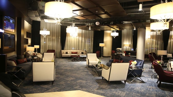 The Petra Lounge at Queen Alia International Airport features a seating area with armchairs, sofas, and tables for passenger comfort.