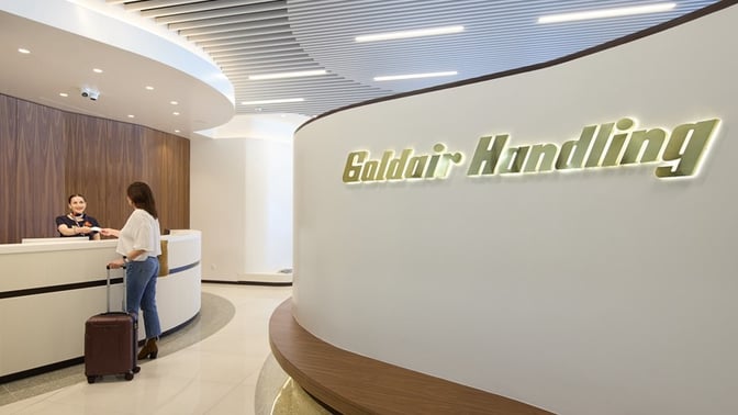 The Goldair Handling Lounge entrance at Rhodes International Airport features a reception desk for guest check-in and assistance.