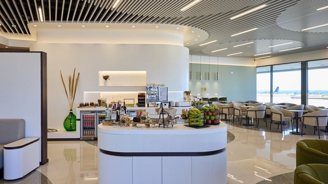 The Goldair Handling Lounge at Rhodes International Airport features a self-serve snack station with seating offering views of the runway.