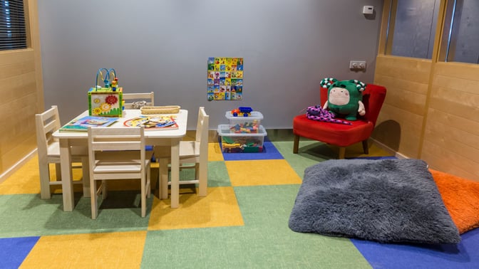 The children's play area in the Primeclass Business Lounge at Riga International Airport features a table with toys and seating.