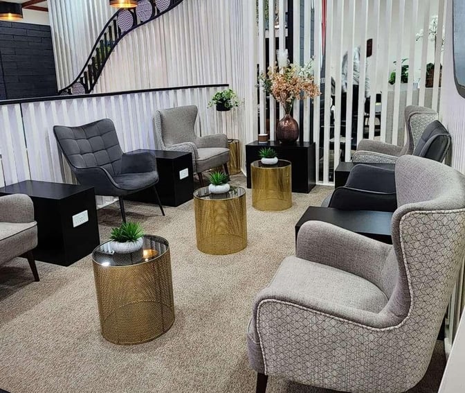 The seating area at Vhakacha Lounge features comfortable armchairs and small tables, providing a relaxing space for travelers at Robert Mugabe International Airport.