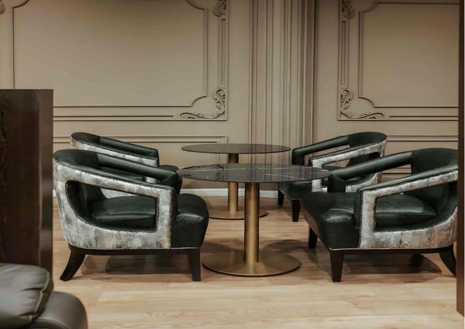 Seating area in the Premium Luxury Lounge at Robert Mugabe International Airport features round tables and upholstered chairs for passenger comfort.