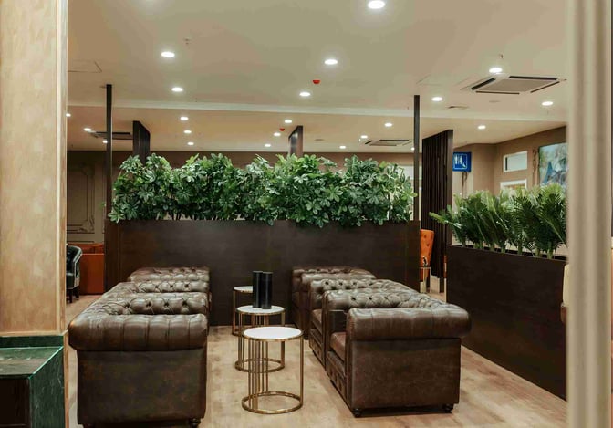 The seating area in the Premium Luxury Lounge at Robert Mugabe International Airport features comfortable chairs and tables with privacy dividers.
