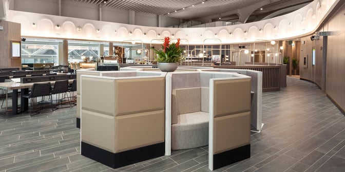 The Plaza Premium Lounge at Leonardo da Vinci-Fiumicino Airport features semi-private seating areas and communal tables for travelers.