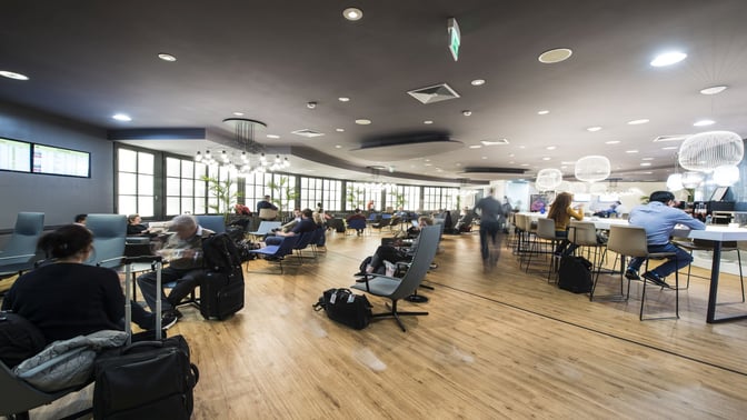 The Prima Vista Lounge at Leonardo da Vinci-Fiumicino Airport features seating areas with tables and high chairs for travelers.