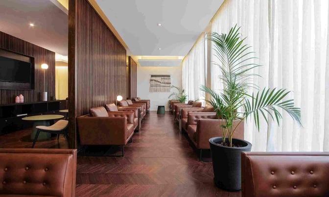 The AMAE Lounge at Rosario - Islas Malvinas International Airport features comfortable seating with armchairs and a television for passenger relaxation.