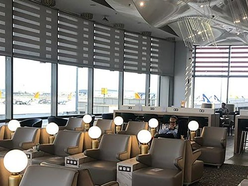 The seating area in Plaza Premium Lounge at Sabiha Gokcen International Airport features comfortable chairs with individual lighting and power outlets.