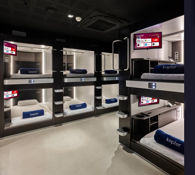 The Kepler Club at Sabiha Gokcen Airport features individual sleeping pods equipped with personal screens and bedding for passenger comfort.