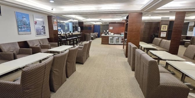 The Hafa Adai Lounge at Saipan International Airport features comfortable seating with tables and a self-serve refreshment area.
