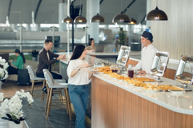 The CIP Lounge at Samarkand International Airport features a self-serve food station with a variety of pastries and beverages.