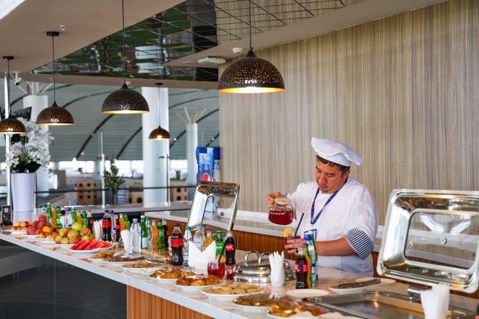 The CIP Lounge at Samarkand International Airport features a self-serve food and beverage station with a variety of drinks and snacks.