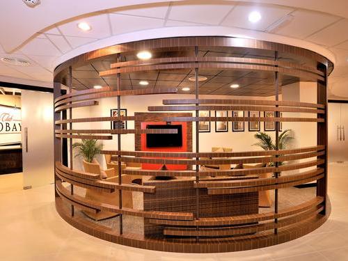 The Club Mobay Arrivals Lounge at Sangster International Airport features a seating area with a television and framed artwork.