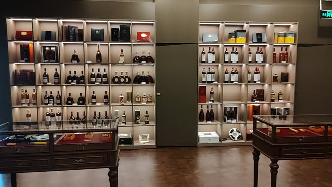 The Cuba Pavilion Lounge at Sanya Phoenix International Airport features a display of various spirits and cigars in glass cases.