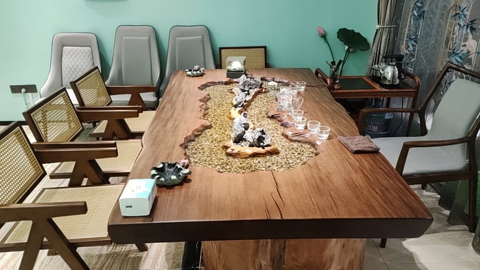 The tea house features a wooden table with decorative elements and seating, providing a space for tea service and relaxation.