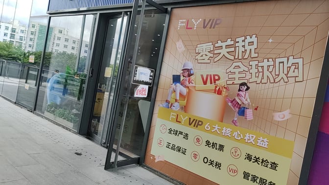 The entrance to the FLYVIP Lounge at Sanya Phoenix International Airport features promotional signage and a glass door.