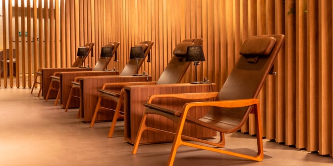 Reclining chairs with individual lamps provide a comfortable seating area in the Plaza Premium Lounge at São Paulo–Guarulhos International Airport.