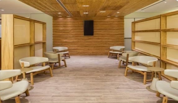 The seating area in GOL Premium Lounge at Sao Paulo–Guarulhos Airport features arranged chairs and partitioned spaces for passenger comfort.
