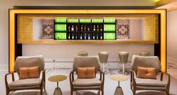The bar area in GOL Premium Lounge at Sao Paulo–Guarulhos International Airport features counter seating and a selection of displayed beverages.