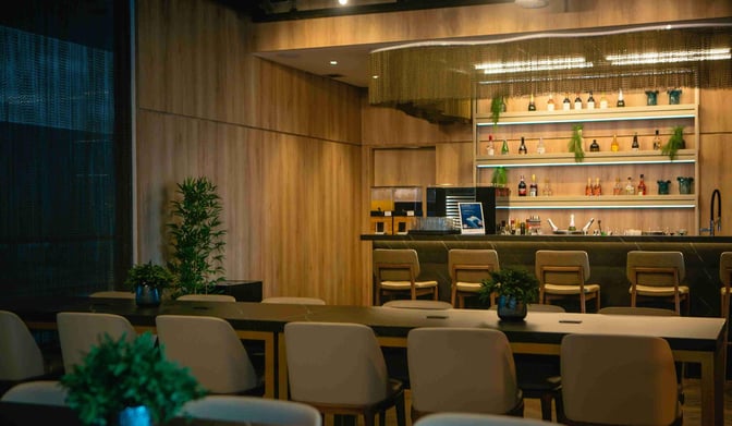 The bar area in W Premium Lounge Guarulhos features a variety of spirits and seating, located at Sao Paulo–Guarulhos International Airport.