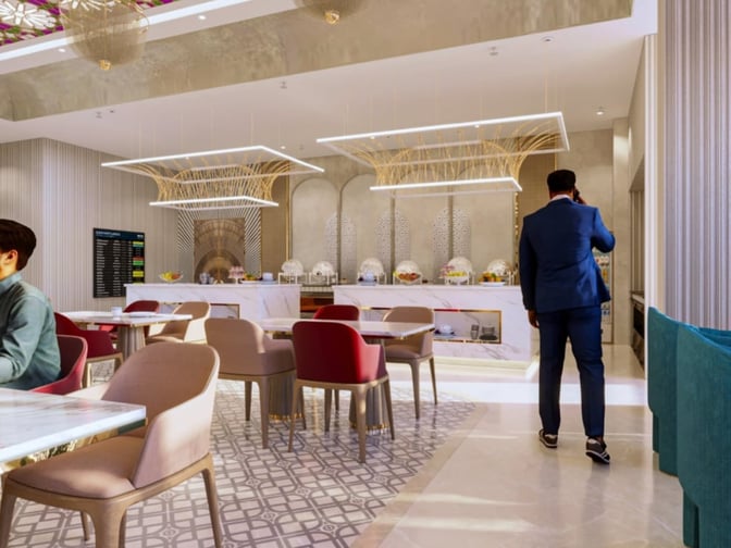 The dining area at Adani Lounge, Sardar Vallabhbhai Patel International Airport, features seating and a buffet with covered dishes.