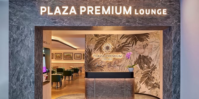 The entrance to the Plaza Premium Lounge at Senai International Airport features a self-check-in kiosk and visible seating area.