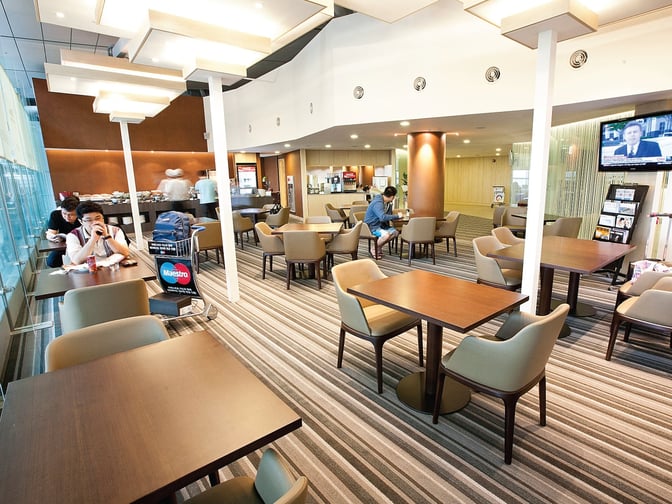 The MATINA Lounge East at Seoul Incheon Airport features a seating area with tables and chairs, offering a comfortable space for travelers.