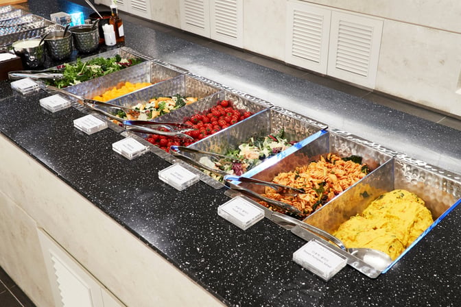The MATINA Lounge West at Seoul Incheon Airport features a self-serve buffet with a variety of salads and pasta dishes.