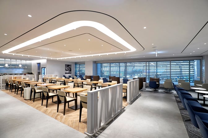 The MATINA Lounge West at Seoul Incheon Airport features a spacious seating area with tables and chairs near large windows.