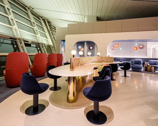 The seating area in the oneworld Lounge at Seoul Incheon International Airport features modern chairs and tables with airport views.