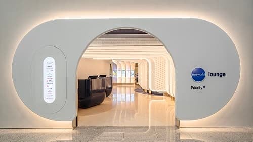 The entrance to the oneworld Lounge at Seoul Incheon International Airport features a sleek design with visible reception desks inside.