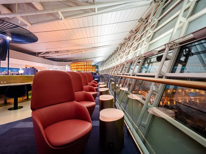 The seating area in the oneworld Lounge at Seoul Incheon offers comfortable chairs with tarmac views through large windows.