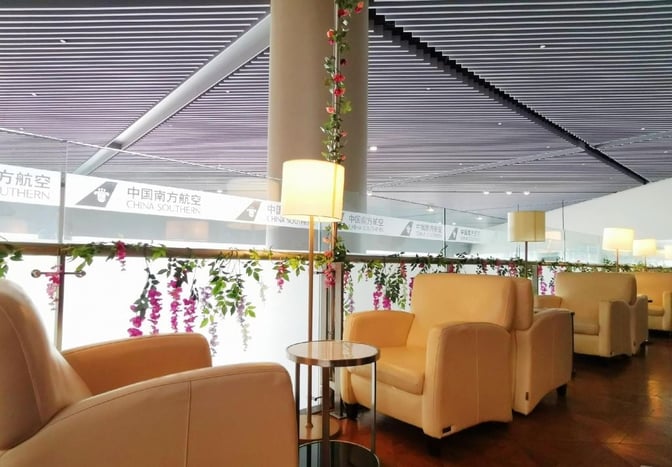 Comfortable seating with armchairs and small tables is available in the China Southern Sky Pearl Lounge at Shanghai Hongqiao International Airport.