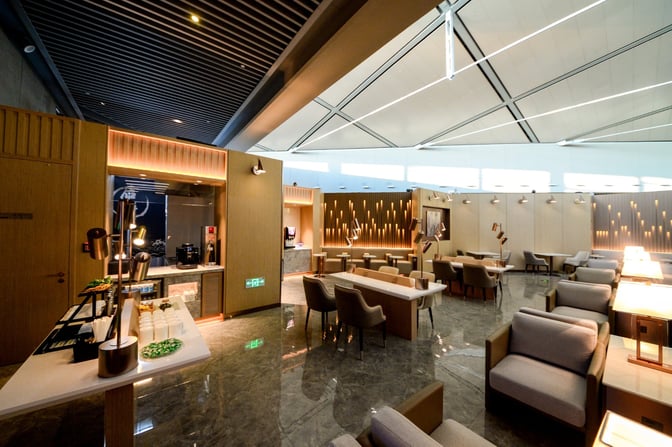 The V01 VIP International Lounge at Shanghai Hongqiao International Airport features a seating area with tables and chairs for relaxation.