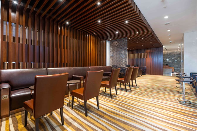 The seating area in the V03 VIP Lounge at Shanghai Hongqiao International Airport features comfortable chairs and tables for relaxation.