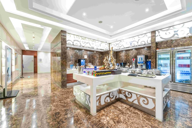 The First Class Lounge at Shanghai Pudong International Airport features a self-serve food area with hot dishes and refrigerated beverages.