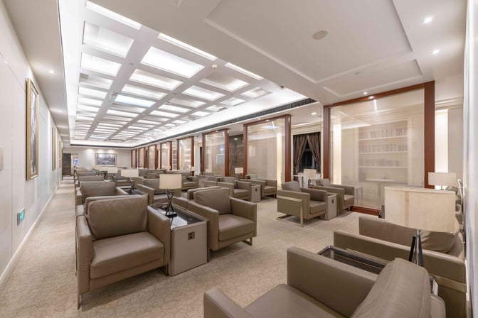 The First Class Lounge at Shanghai Pudong International Airport features spacious seating with individual armchairs and side tables for travelers.