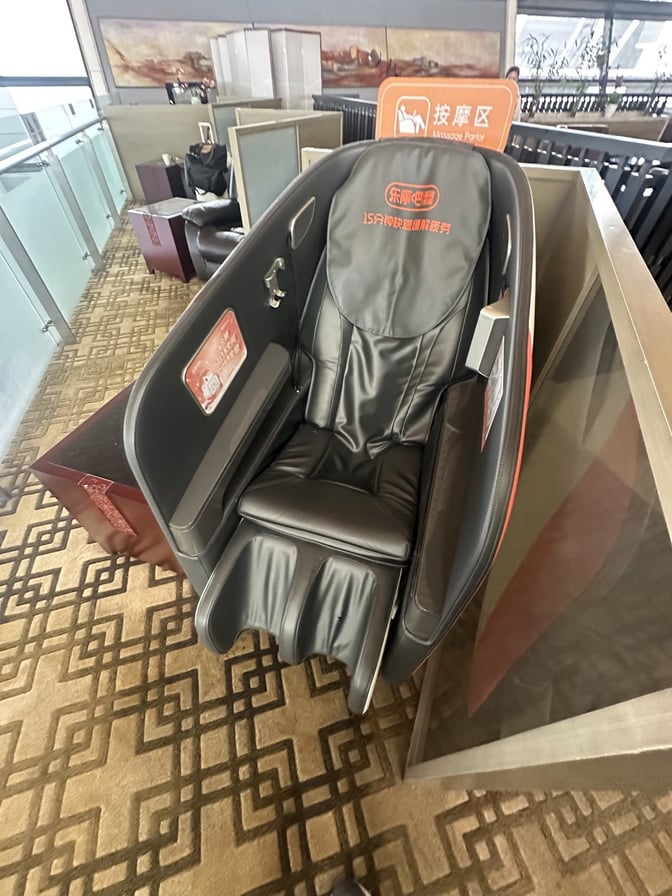 The massage chair area in No. 77 China Eastern Lounge at Shanghai Pudong Airport offers relaxation with individual seating.