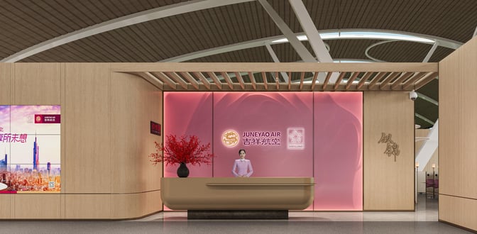 The Juneyao Airlines VIP Lounge entrance at Shanghai Pudong International Airport features a reception desk with a staff member and signage.